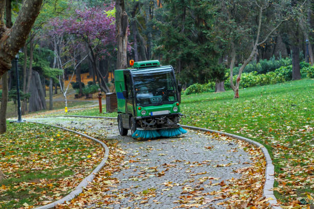 Street sweeper removing leaves Street sweeper removing leaves in Gulhane Public Park, Istanbul street sweeper stock pictures, royalty-free photos & images