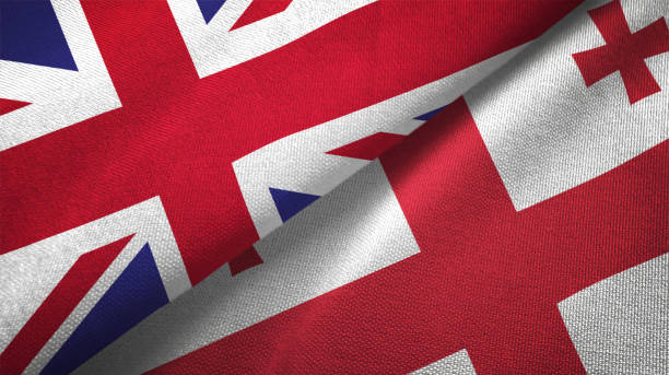 istock Georgia and United Kingdom two flags together realations textile cloth fabric texture 1089726404