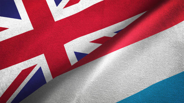 istock Luxembourg and United Kingdom two flags together realations textile cloth fabric texture 1089727716