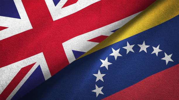 istock Venezuela and United Kingdom two flags together realations textile cloth fabric texture 1089728330