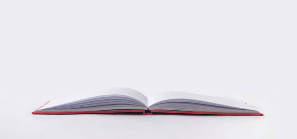 Perspective red notebook with open page Design concept - Perspective view red hardcover notebook with open & flip curl rolled page isolated on background for mockup. Not 3D render handbook book hardcover book red stock pictures, royalty-free photos & images