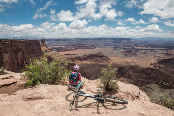 Female mountainbiker at Dead Horse Point State Park Viewpoint, Moab, Utah.