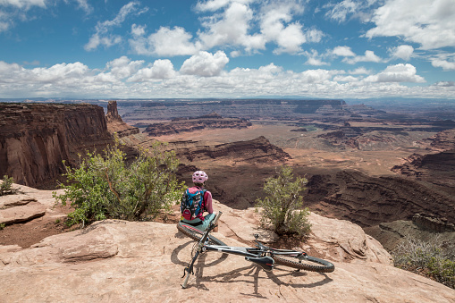 A female mountainbiker is taking a break overlooking Canynonlands National Park from the rim of Dead Horse Point State Park. Dead Horse Point State Park is a state park of Utah in the United States, featuring a dramatic overlook of the Colorado River and Canyonlands National Park. The park covers 5,362 acres (2,170 ha) of high desert at an altitude of 5,900 feet (1,800 m).
Canon EOS 5D Mark IV, 1/160, f/16, 24 mm.