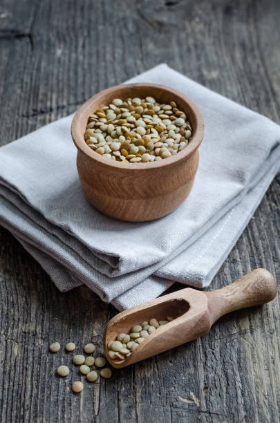 istock Brown dried lentils in a wooden bowl 1089739132