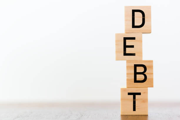 istock Debt written on wooden cubes on white background 1089739930