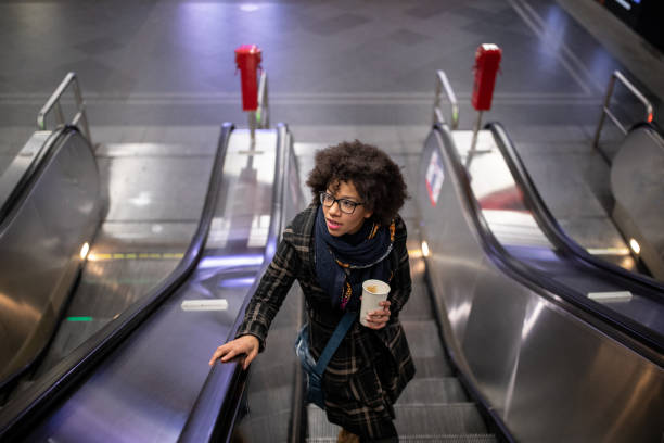 istock Young woman on the escalator 1089741744