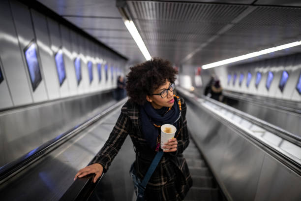Young woman on the escalator
