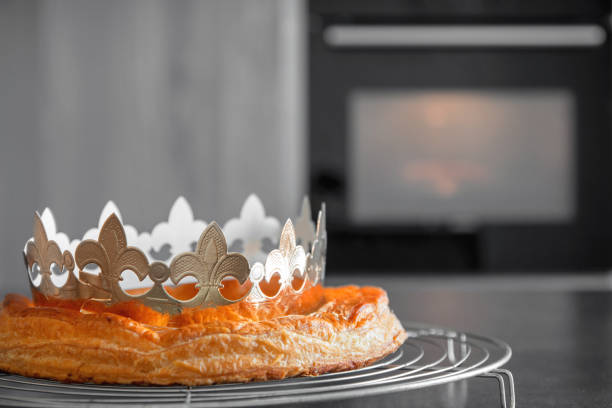 Homemade Epiphany King's cake french pastry close-up with traditional paper golden crown for celebration in january stock photo
