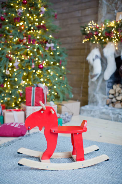 istock red rocking reindeer near Christmas tree 1089747802
