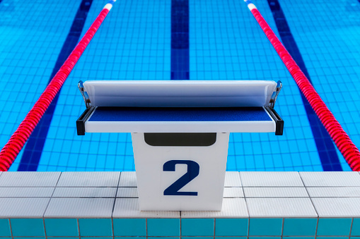 Empty modern swimming pool with starting block