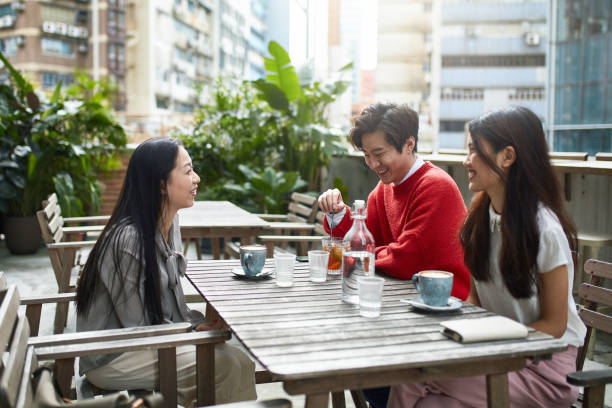 istock Smiling Chinese friends communicating at cafe 1089751072