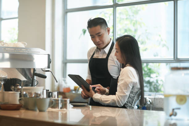 istock Baristas using digital tablet at counter in cafe 1089752402