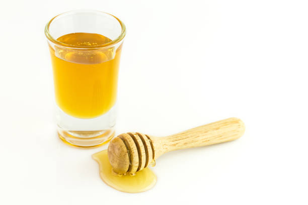 istock Honey with wooden isolated on a white background 1089754774