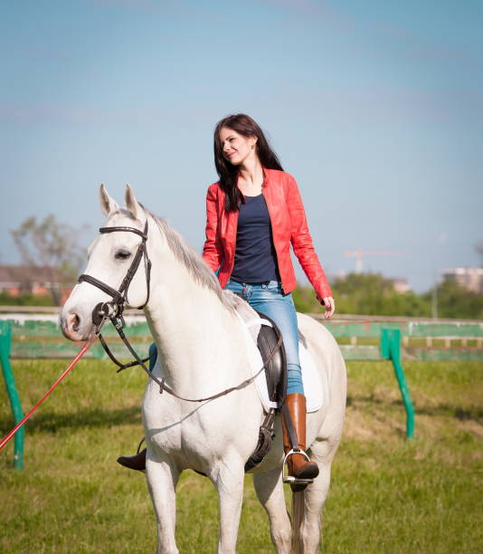 istock Woman sitting  horse. Day. Full height. Red leather jacket 1089755708
