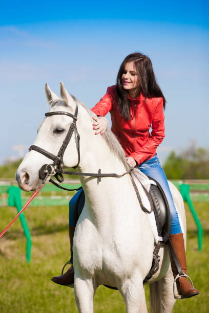 istock Woman sitting  horse. Day. Half height. Red leather jacket 1089755944