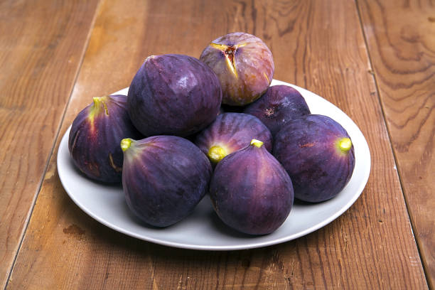 istock Figs on the wooden background. 1089756198