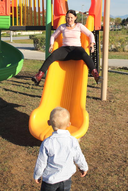 istock mother and son having fun together on a slide 1089757840