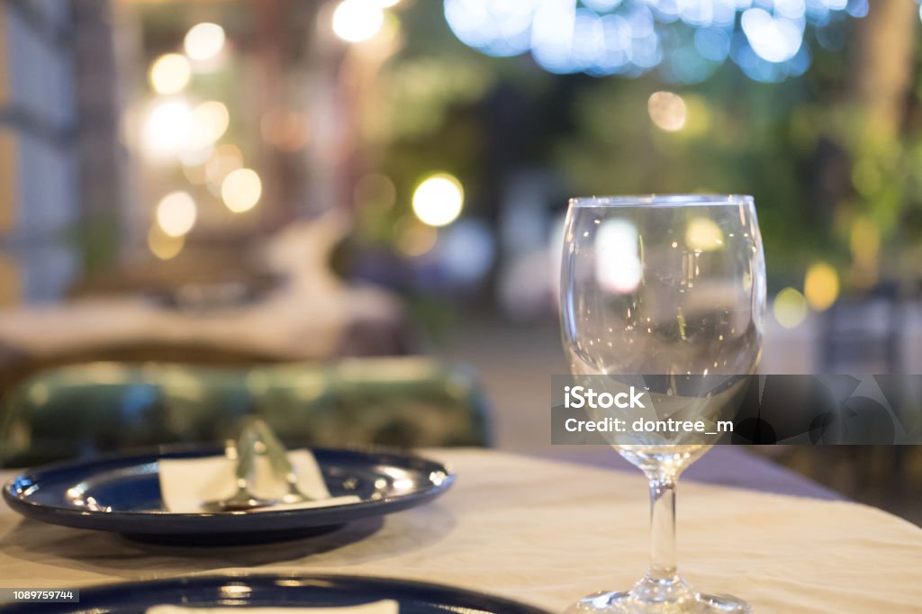Wine glass setup on the dinner table in luxury dinner party blurry background with night light Alcohol - Drink Stock Photo