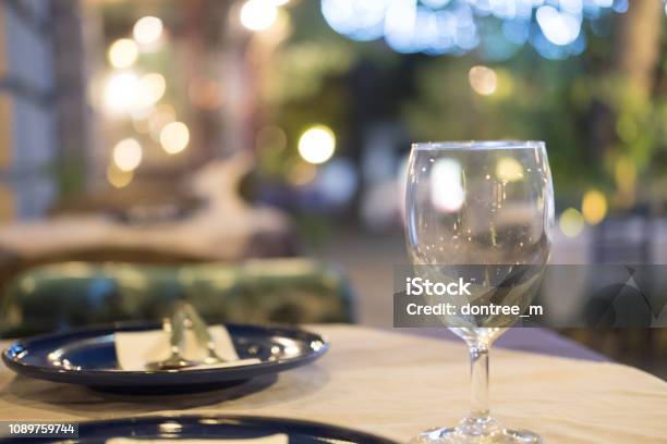 Wine Glass Setup On The Dinner Table In Luxury Dinner Party Blurry Background With Night Light Stock Photo - Download Image Now