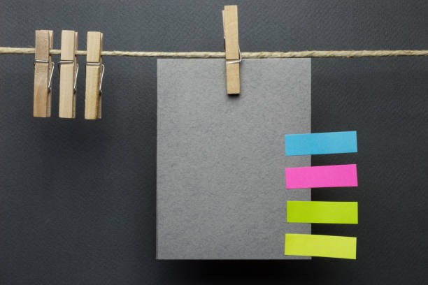 istock Blank card with colorful post it note on the string over black background 1089766318