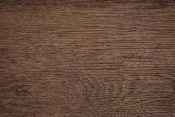 Rough dark wood texture Rough dark wood background. A wood grain pattern featuring even grains of wood running horizontally across the image. The board is old and weathered, but in good condition. walnut wood photos stock pictures, royalty-free photos & images