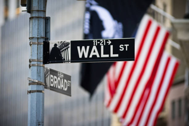 Wall street sign with American flag in the Financial District of Lower Manhattan stock photo
