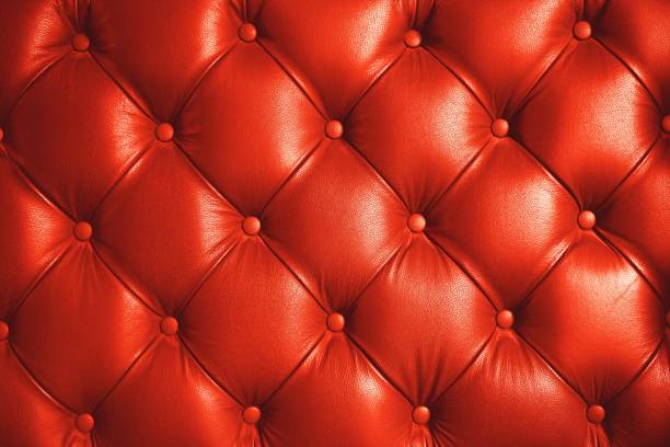 istock Living coral tone, pink orange color leather sofa pattern texture background, copy space, luxury background concept 1089776686