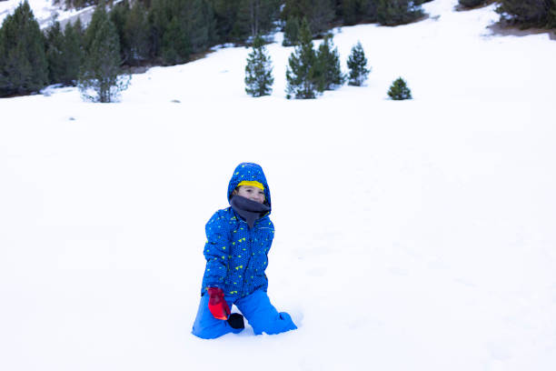 istock Boy playing with the snow on a winter day 1089778470