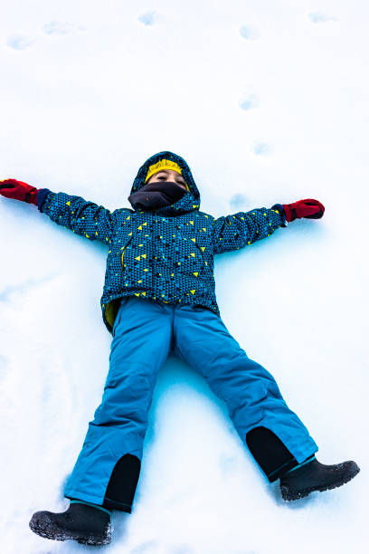 istock Little boy lying on a snowy field 1089778516