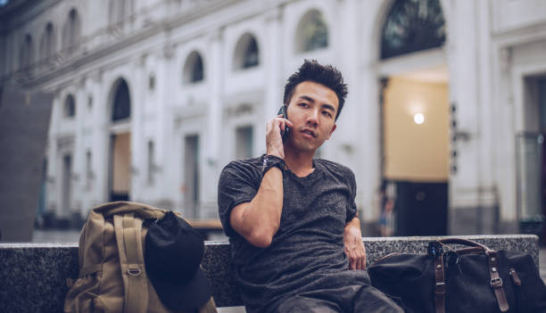 istock Chinese man sitting at train station 1089778962