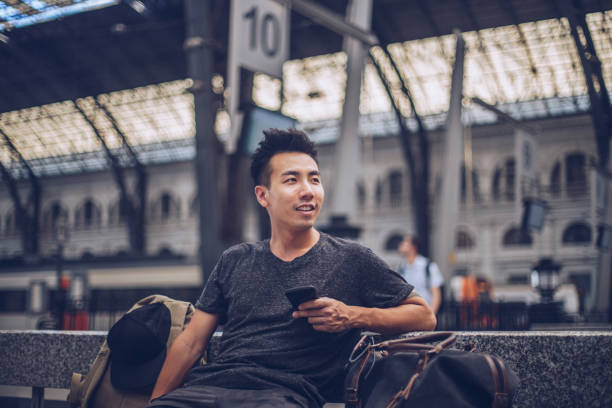 istock Chinese young man waiting a train 1089779078
