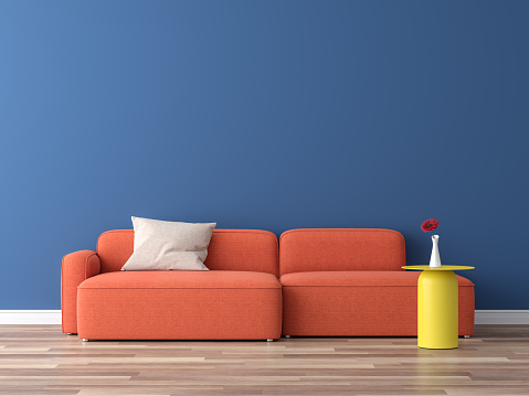 Minimal style interior colorful concept 3d render,There are wood floor,navy blue empty wall,decorate with orange fabric sofa and yellow table.