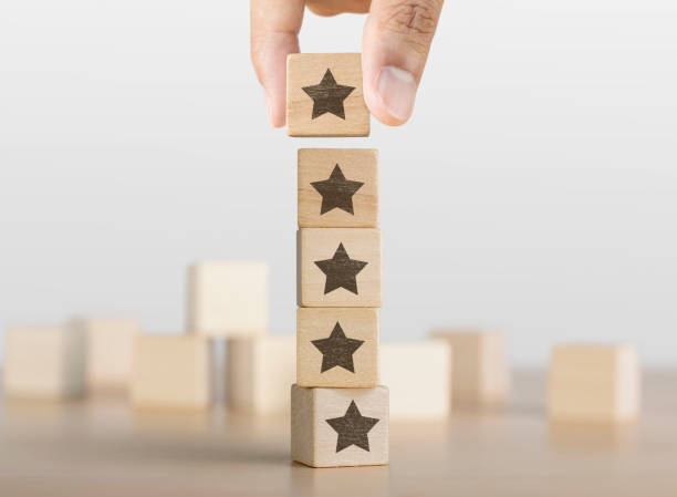 Hand arranging wooden blocks with the five star symbol. The best rating, the best ranking, the best service, goal, success concept. stock photo