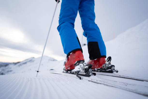 istock close up man skier fastening skis on slope 1089784980