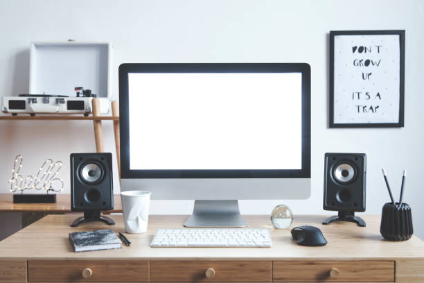 istock White scandinavian interior of home creative desk with mock up computer screen, photo frame, speakers, office accessories and gramophone. Minimalistic space for work, hobby and listen music. 1089786442