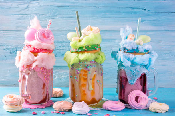 Freakshakes with donuts Freakshakes with donuts and candy floss milkshake stock pictures, royalty-free photos & images