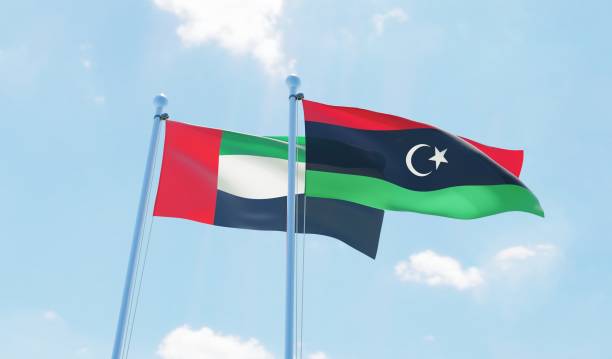 istock UAE and Libya, two flags waving against blue sky 1089796410
