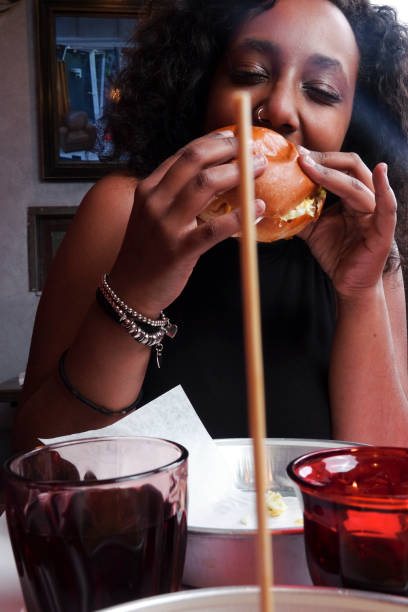 istock Black girl eating a sandwich 1089800296