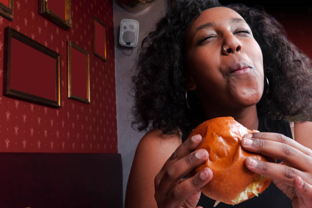 istock Black girl eating a sandwich 1089800312