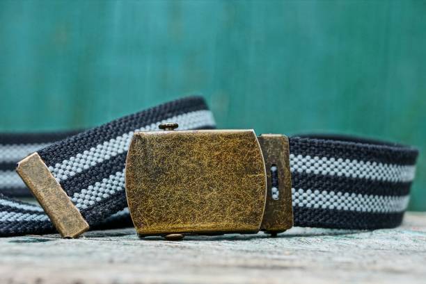 istock one striped belt with an iron brown buckle lies on a gray table 1089801846