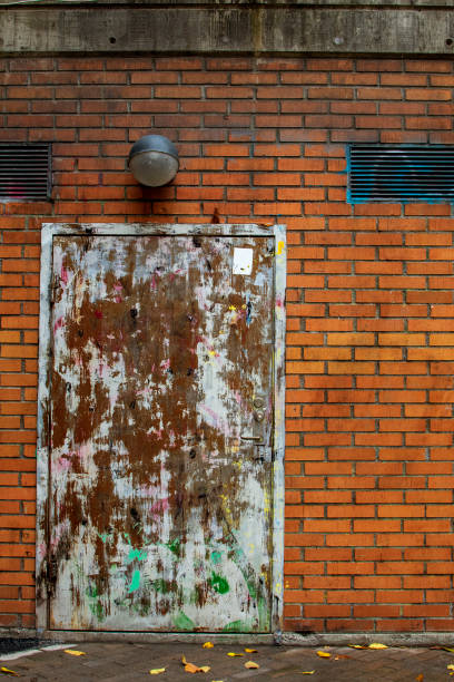 istock Brick building with old peeling door. 1089807490