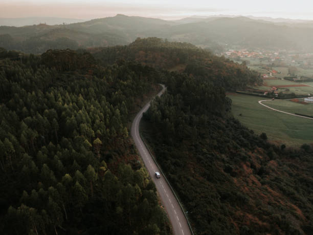 istock Car on a road with curves by a forest 1089808430