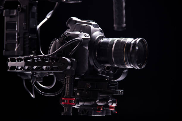 istock System stabilization video camera and lens on steady equipment support such as gimbal steady or stabilized. Black background 1089810442