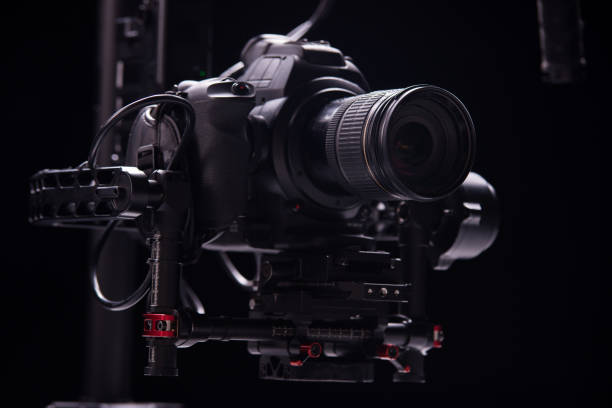 istock System stabilization video camera and lens on steady equipment support such as gimbal steady or stabilized. Black background 1089810458
