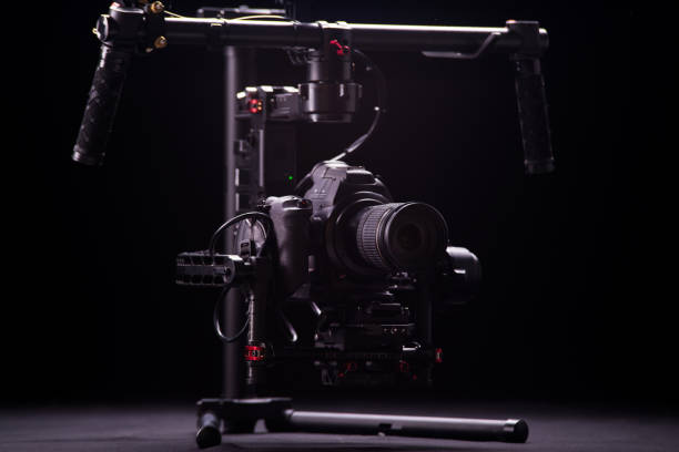 istock System stabilization video camera and lens on steady equipment support such as gimbal steady or stabilized. Black background 1089810464