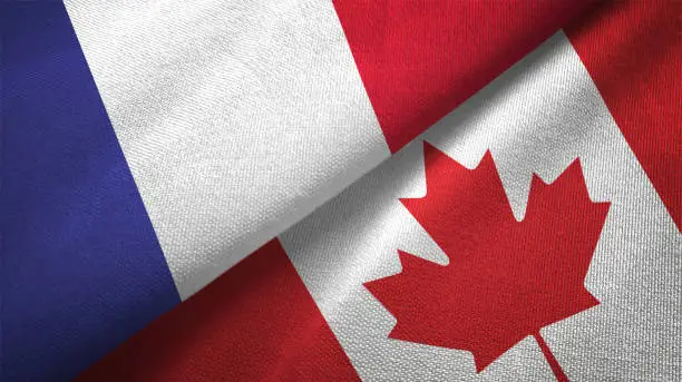 Photo of Canada and France two flags together realations textile cloth fabric texture