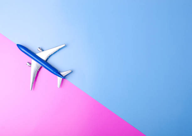 Blue model plane,airplane on color pink blue background, top view