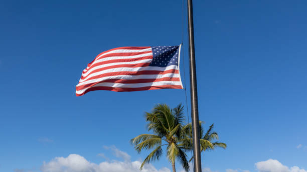 istock American flag waving in blue sky 1089821232
