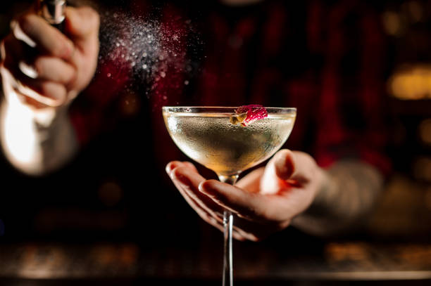 istock Mixologist sprinkling bitter on the elegant cocktail glass 1089829456