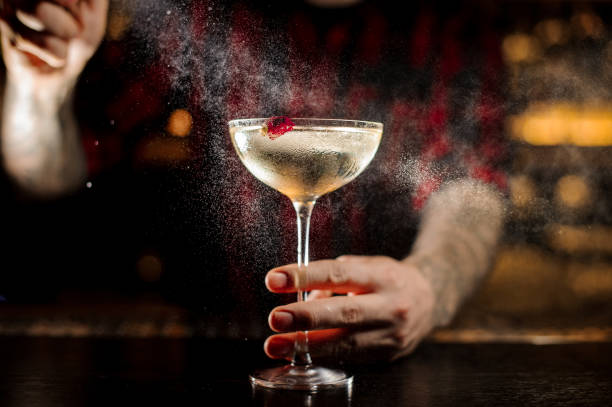 istock Barman sprinkling bitter on the elegant cocktail glass 1089829516
